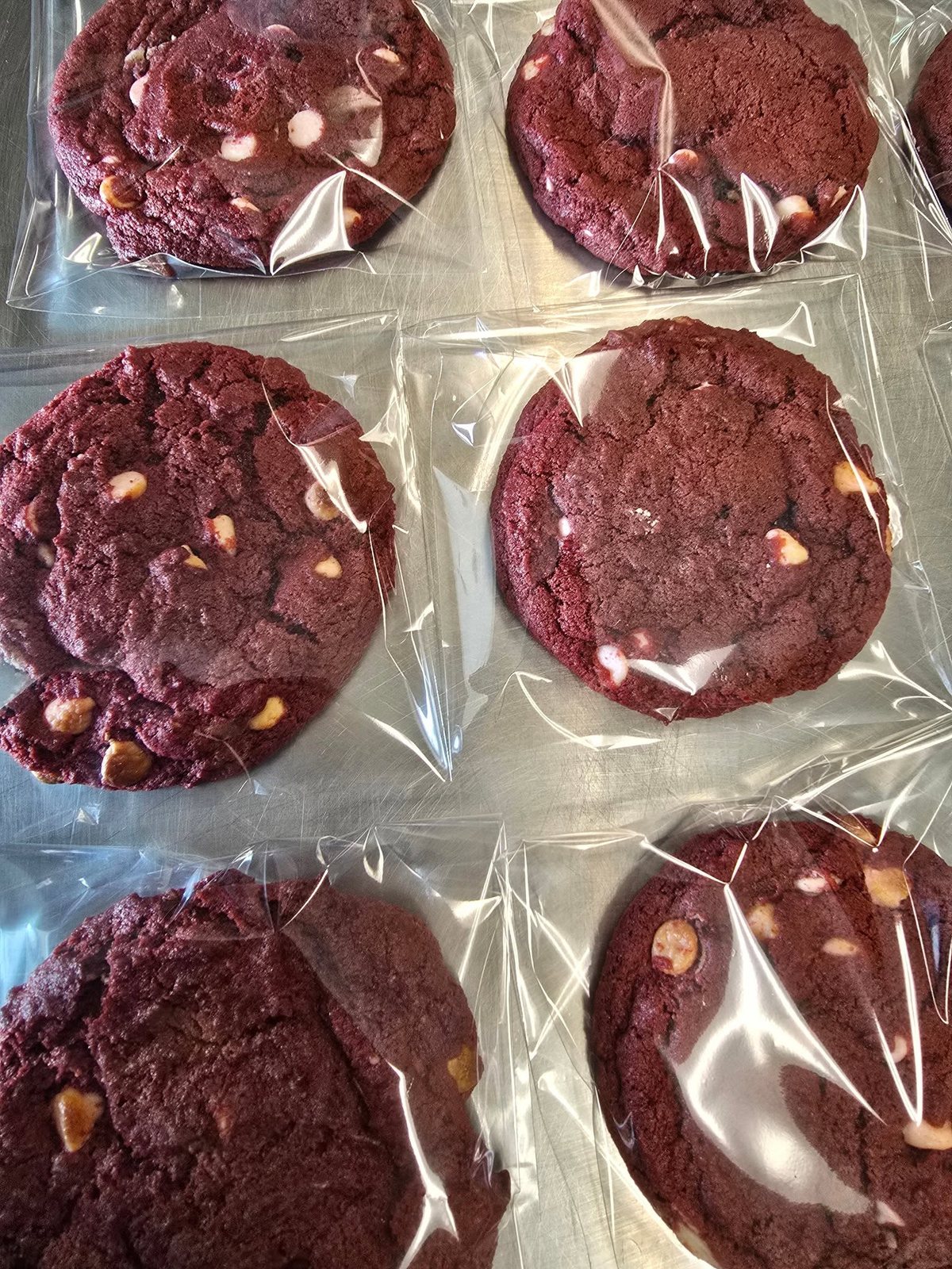 Red velvet cookies with white chocolate chips, wrapped by the piece